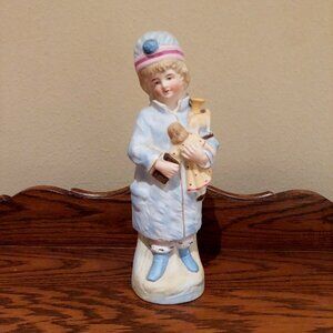 Antique German Bisque Figurine Of A Girl Holding Doll And Toys
